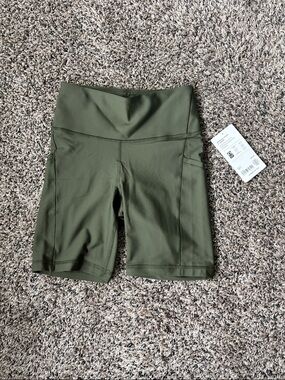 Athleta interval stash 7” Olive Green High-Rise Bike Shorts